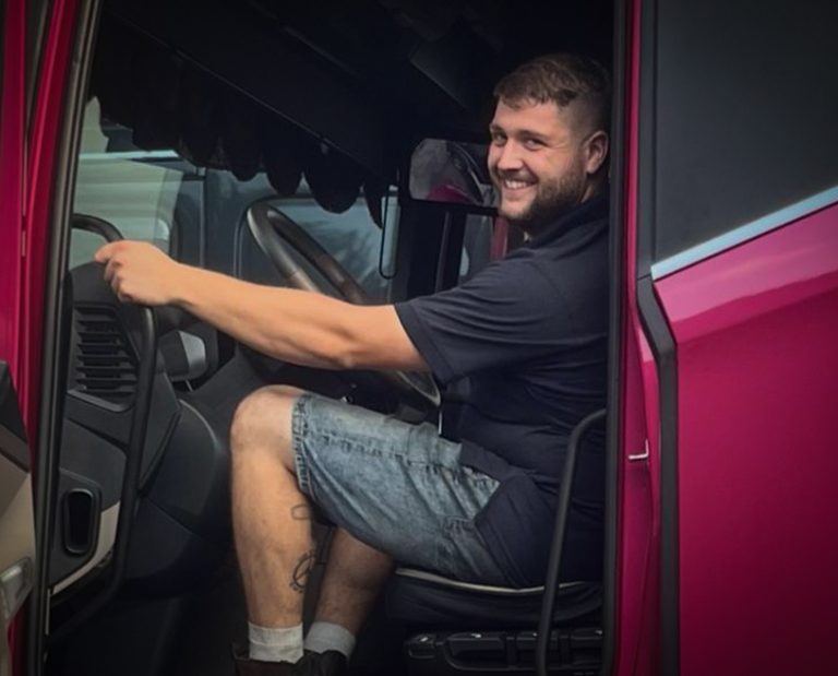 A man sat in the cab of his lorry